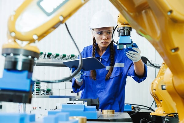 machine tending robot operator inspecting the machine_569596236